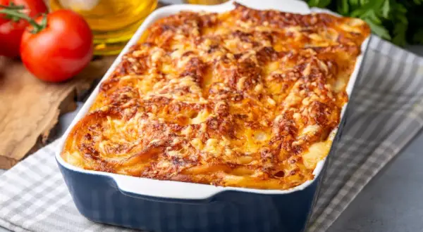 Zapiekanka ziemniaczana z beszamelem i serem, zapieczona na złoto w niebieskiej brytfance.